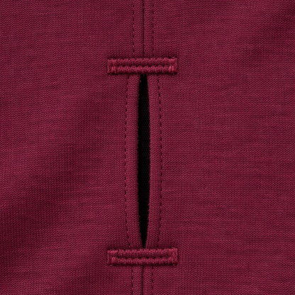 Close-up of a burgundy dog t-shirt with stitching detail