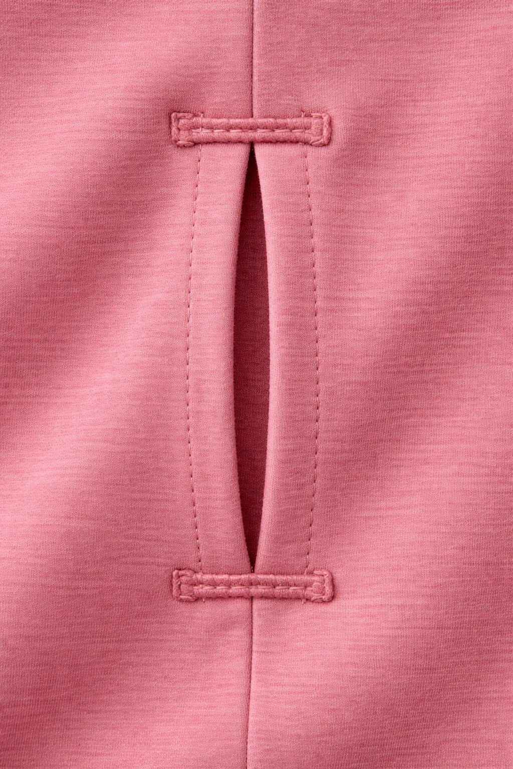 Close-up of a pink fabric with button details