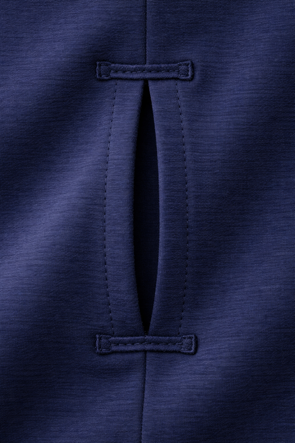 Close-up of a navy blue fabric with a button detail
