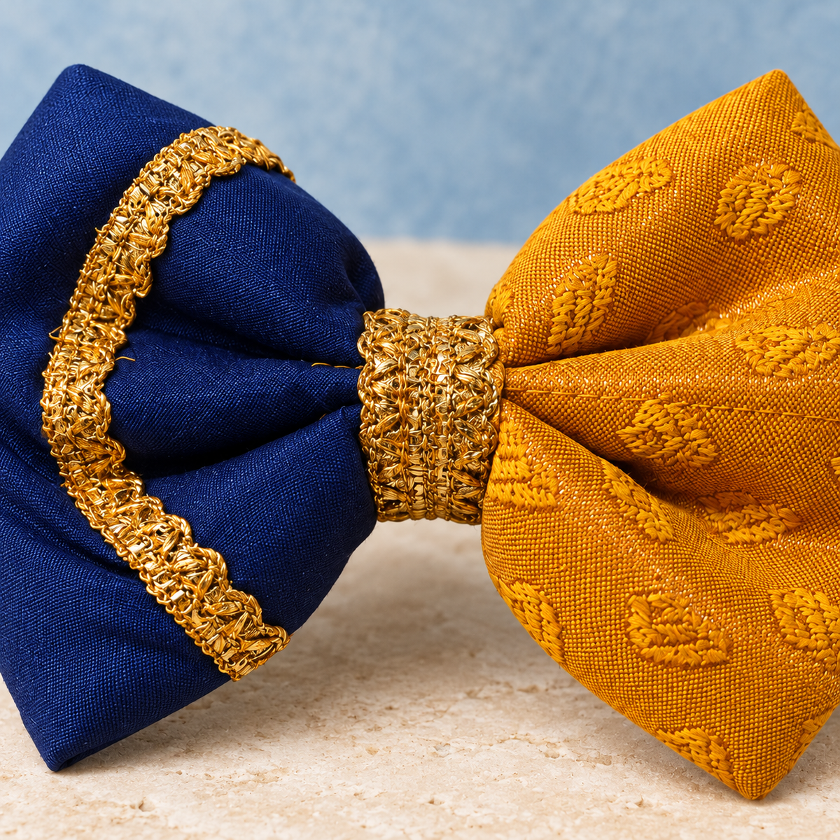 Close-up of the Kesari mustard yellow and navy ethnic dog bow with antique-gold detailing.
