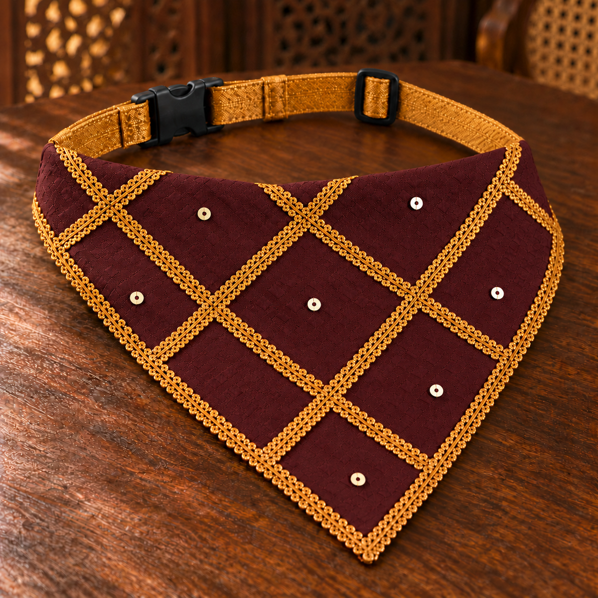 Close-up of FurJeevan’s Maroon & Gold Ethnic Dog Bandana, showing maroon woven fabric, gold braid trims and sequin detailing.