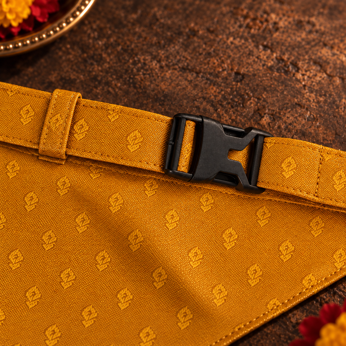 Close-up of the adjustable mustard-yellow jacquard neck strap and black side-release buckle on the ethnic dog bandana.
