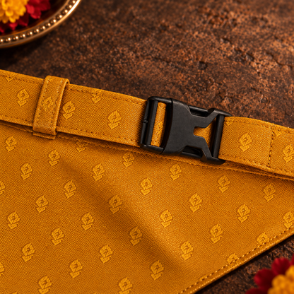 Close-up of the adjustable mustard-yellow jacquard neck strap and black side-release buckle on the ethnic dog bandana.
